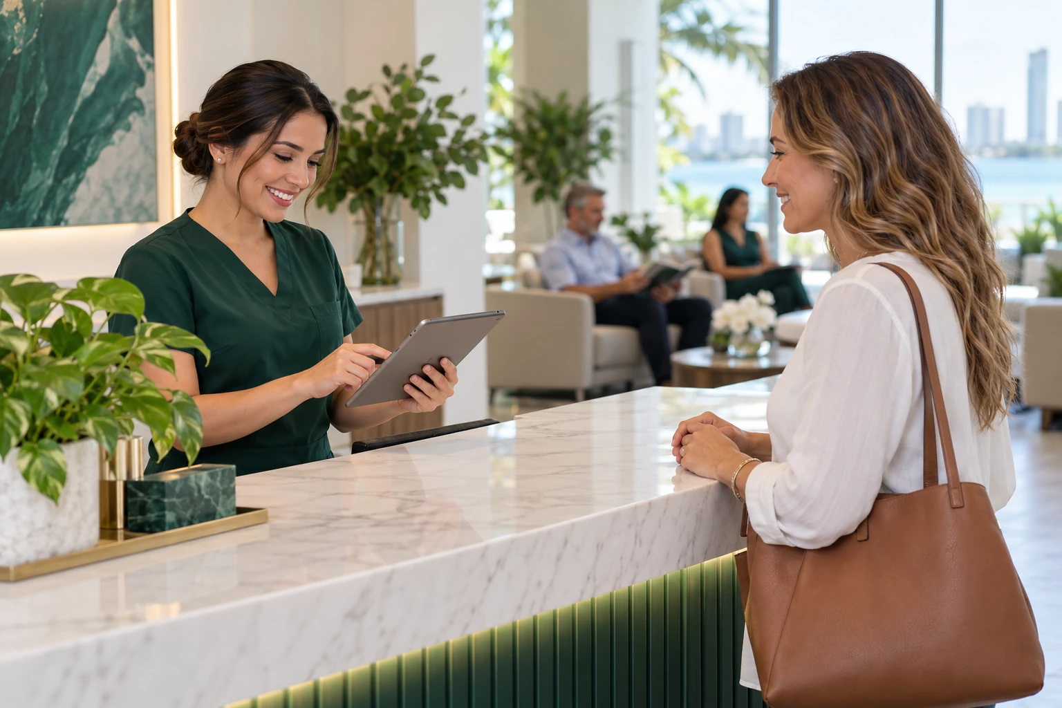 Clinic receptionist confirming an appointment on a tablet with a patient.